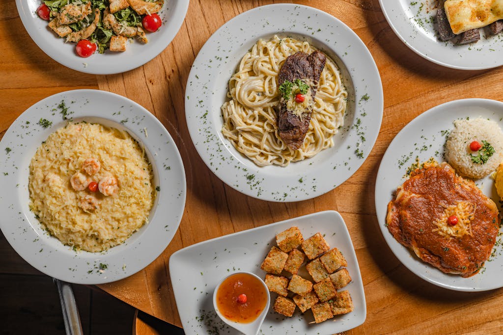 A top view of various gourmet dishes beautifully plated, showcasing Brazilian cuisine.